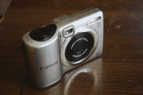 Canon Powershot AS1300 from the front with lens retracted and covered