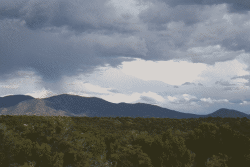 Clouds over the southeastern edge of the Rocky Montains, verdant with trees