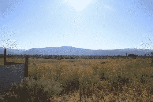 An expanse of high grasslands and the distant Jimez mountains in Rancho de Taos