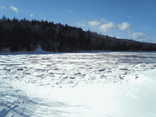 Ice and snow cradle the coastal hills in the deep winter in Maine