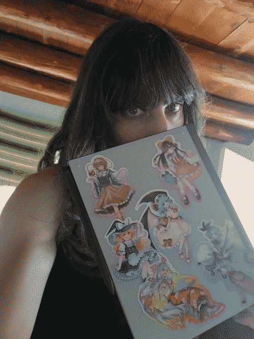 green-streaked Iris pokes her eyes over her reMarkable, the back of which is covered in Touhou girls; behind her are New-Mexico style rafters and the washed out light of day coming through the window