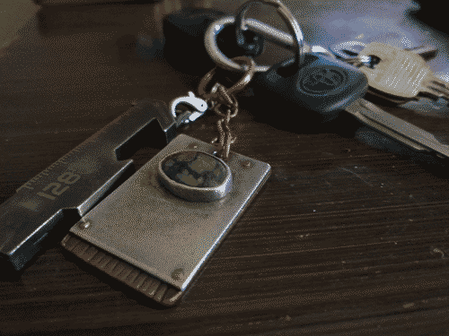 Keys on a carabiner - USB key and lucky charm in front, car key + fob and some other nondescript keys visible in the background