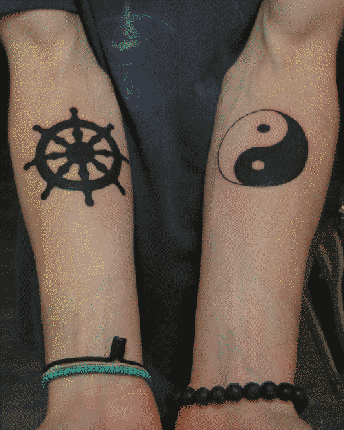 Yin yang and Dharma wheel tattoos ~36 hours after completion