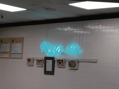 Neon cursive lettering of "Pizza etc." on a classic white tile wall, with some framed awards and stuff adorning the wall below it