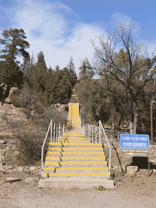 Very tall yellow-painted stairway to Nowhere