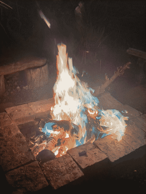 Rainbow flames in a brick fire pit