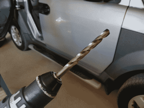 A drill with a seriously hefty bit installed to pierce the Element